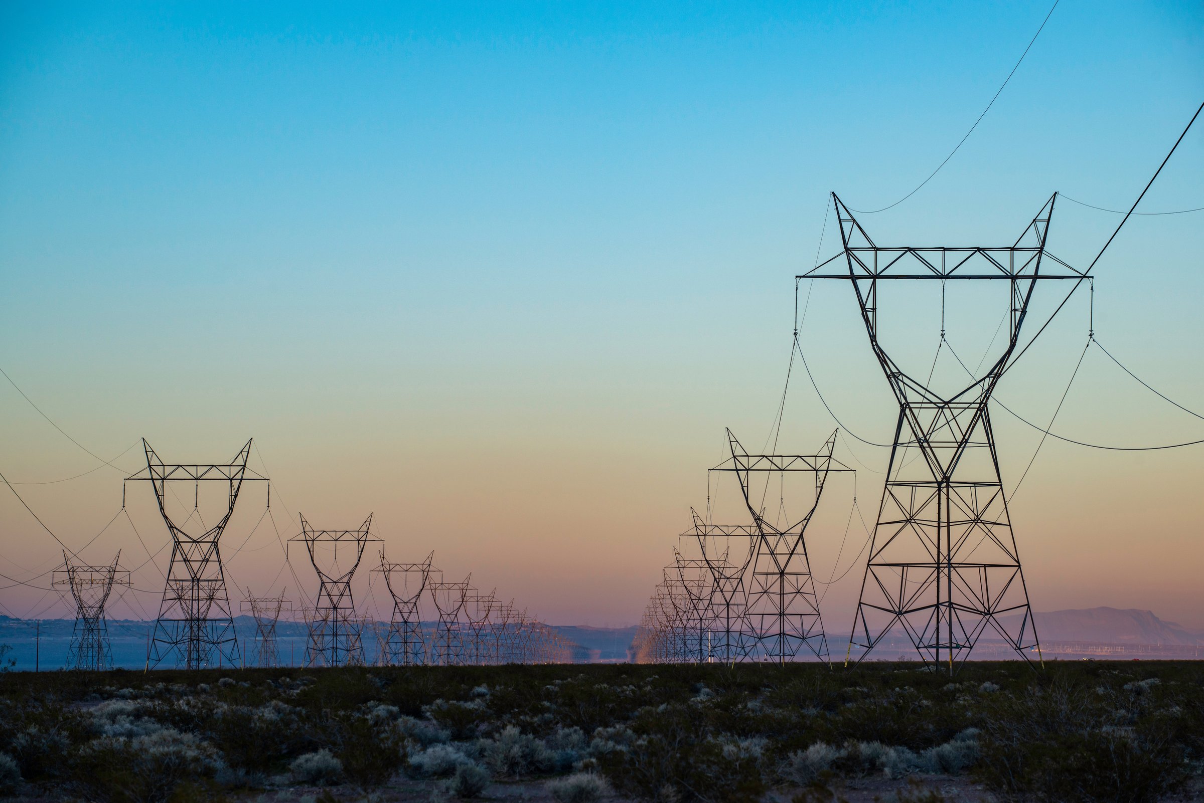 High-voltage transmission towers at dusk