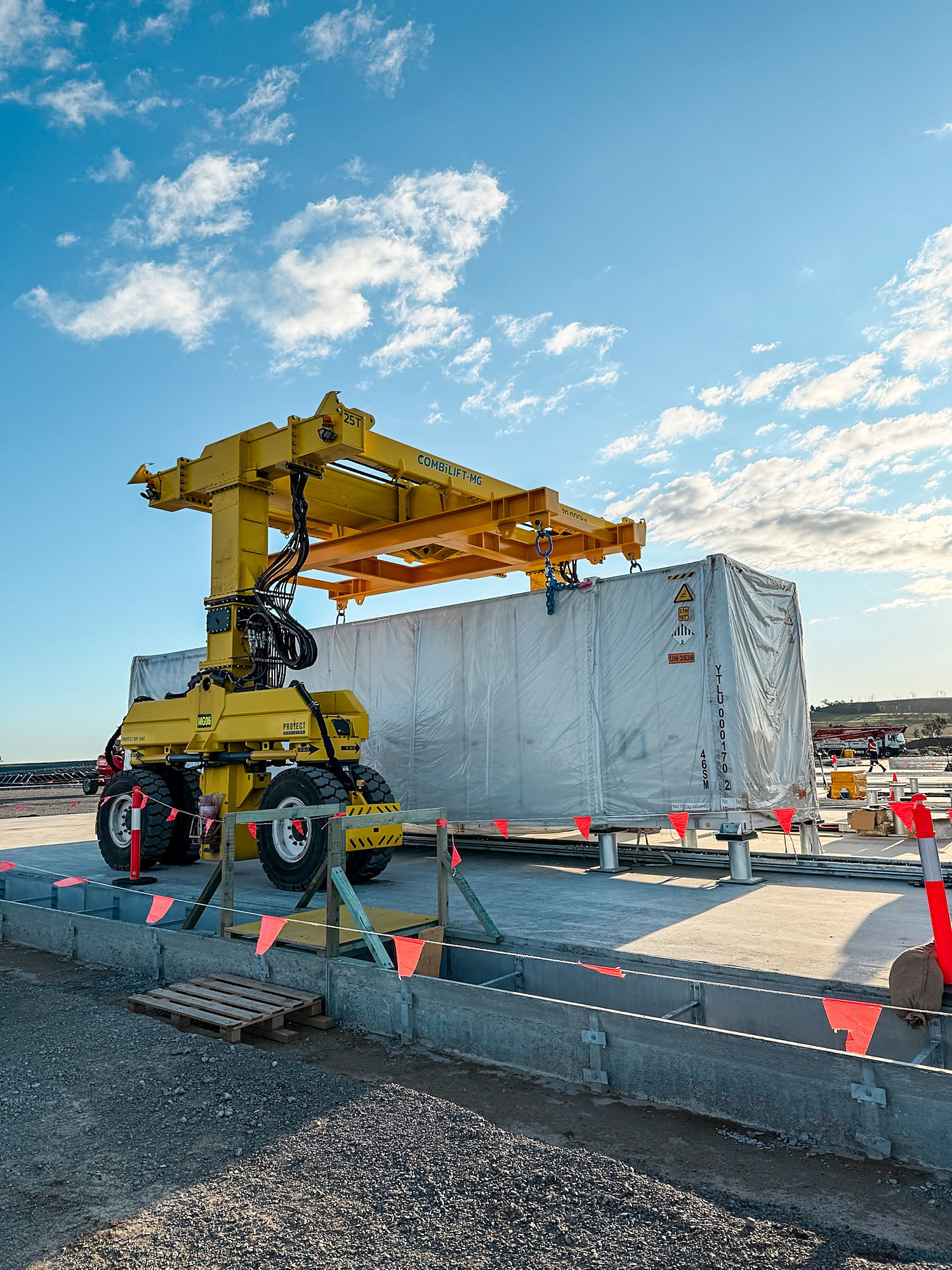 Battery container being lifted into place by crane
