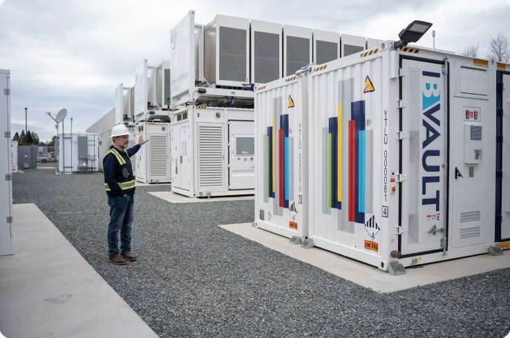 Technician beside B-VAULT battery enclosures at the Calistoga Resiliency Center
